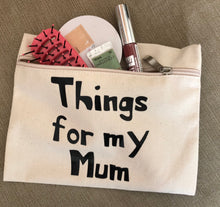 Load image into Gallery viewer, A canvas zip up purse with things for my mum printed on it and a hairbrush and make up items poking out of the zip.